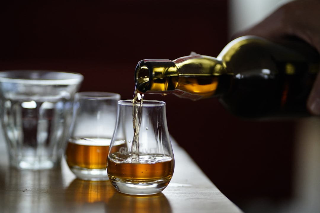 Two glasses of whisky on a wooden table