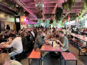 Packed Edinburgh Street Food venue during a Premier SpeedQuizzing night — disco ball overhead, full tables throughout