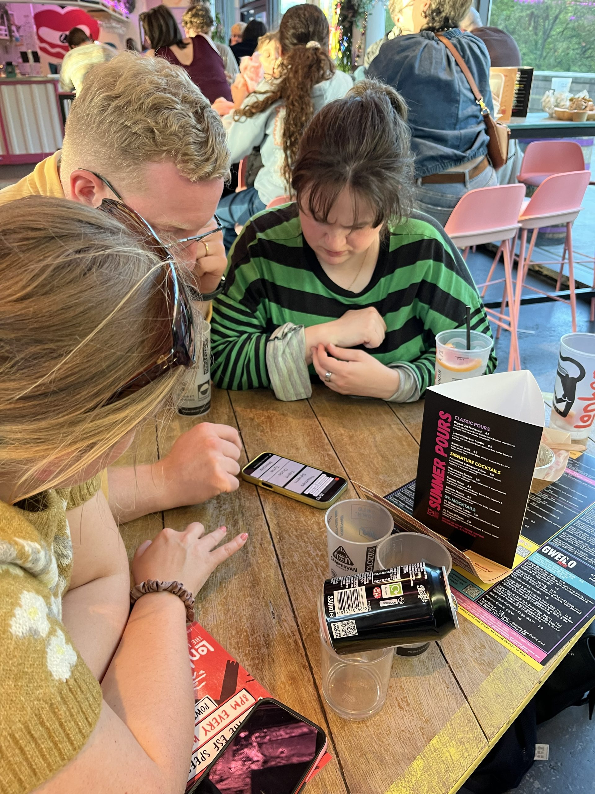 Players checking answers at a Premier SpeedQuizzing public event Edinburgh