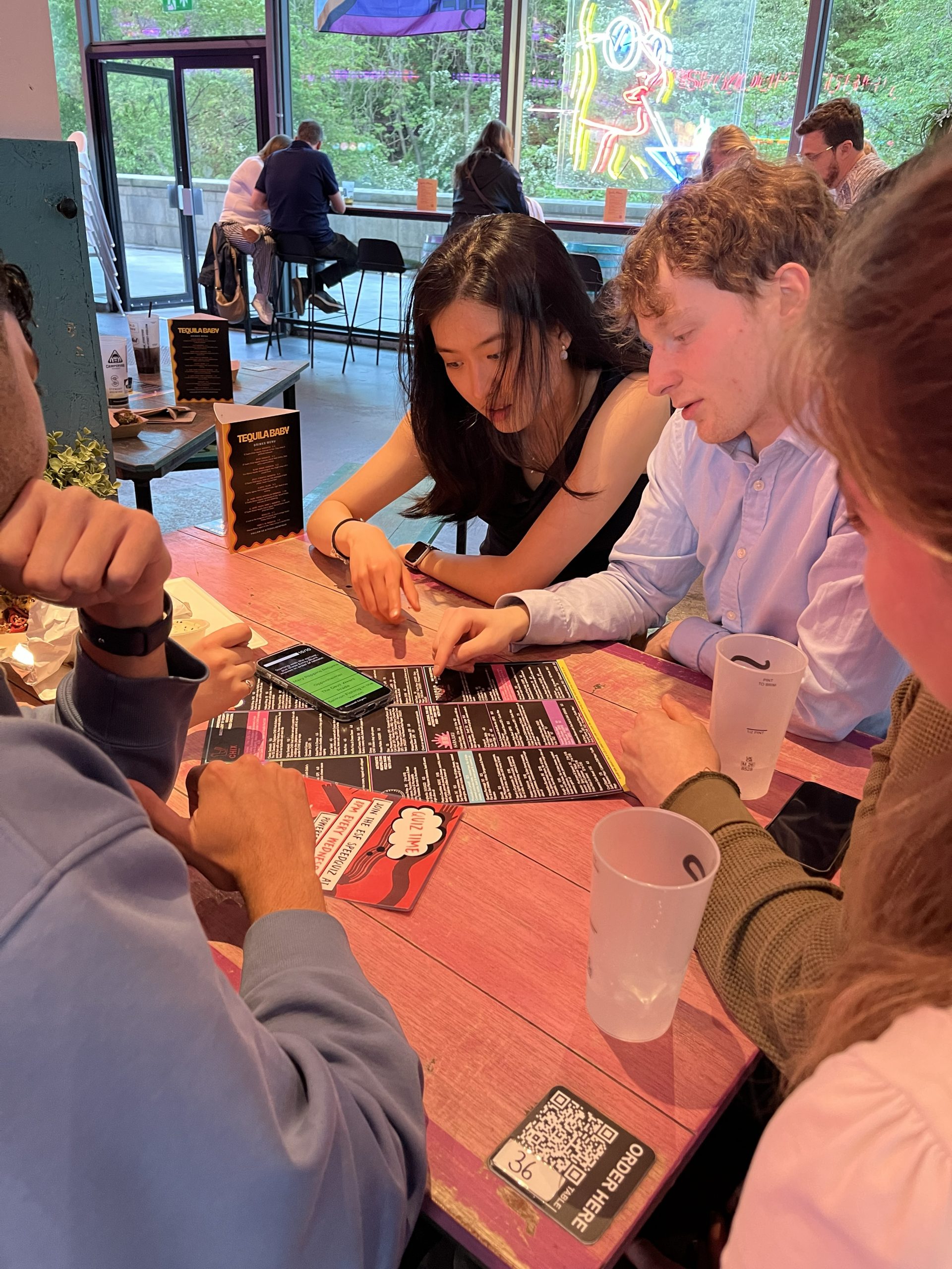 Group of players studying SpeedQuizzing flyer at Edinburgh Street Food