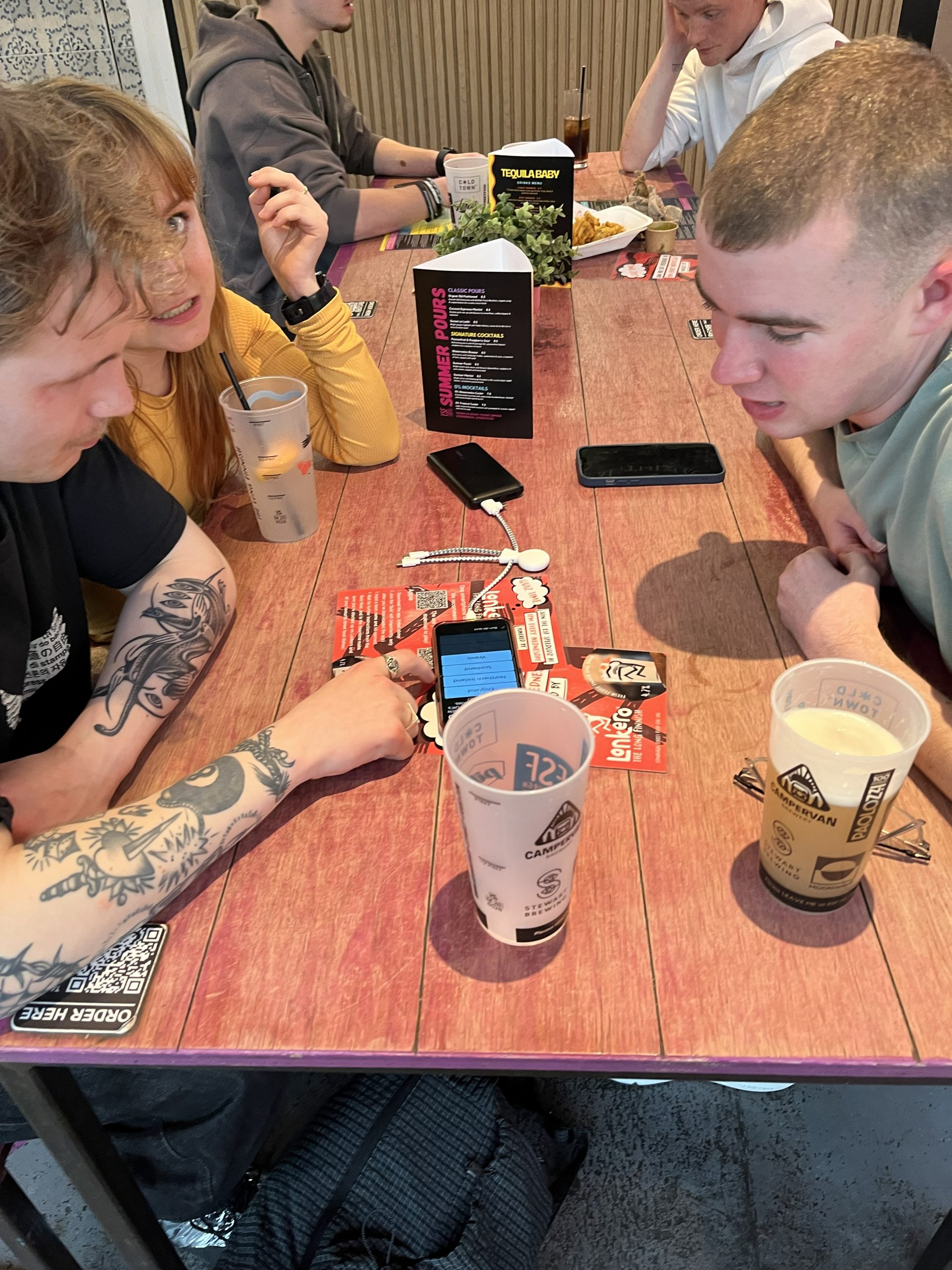 Two players at a table using their phones at Edinburgh Street Food SpeedQuizzing