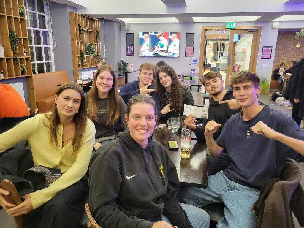 Quiz winners To The Max celebrating with their prize cheque at Premier SpeedQuizzing's quiz night at The Pleasance Café & Bar, Edinburgh